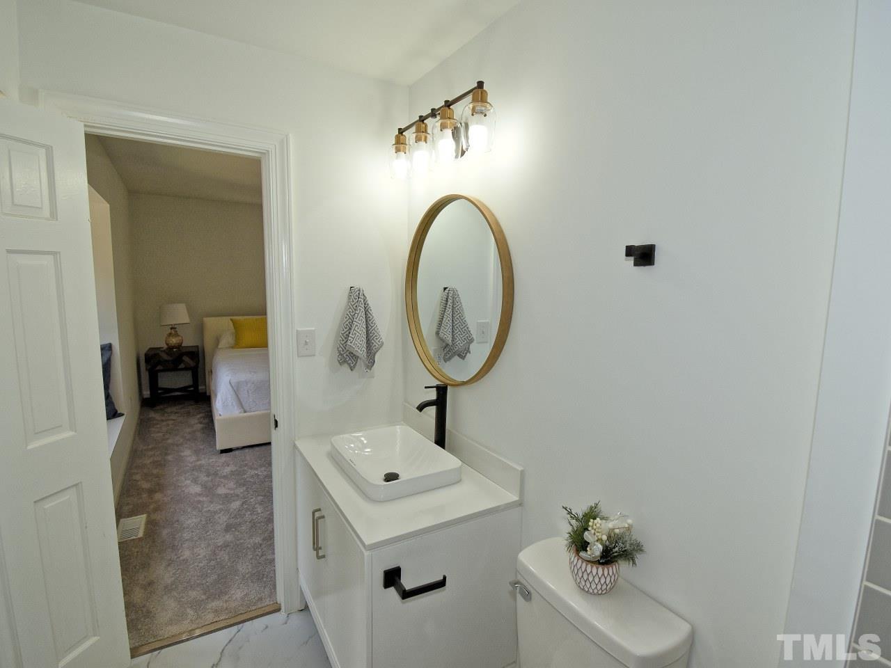 6530 Jean Drive Raleigh, NC 27612 - Photo 20 of 32 a view of living room with a sink and mirror