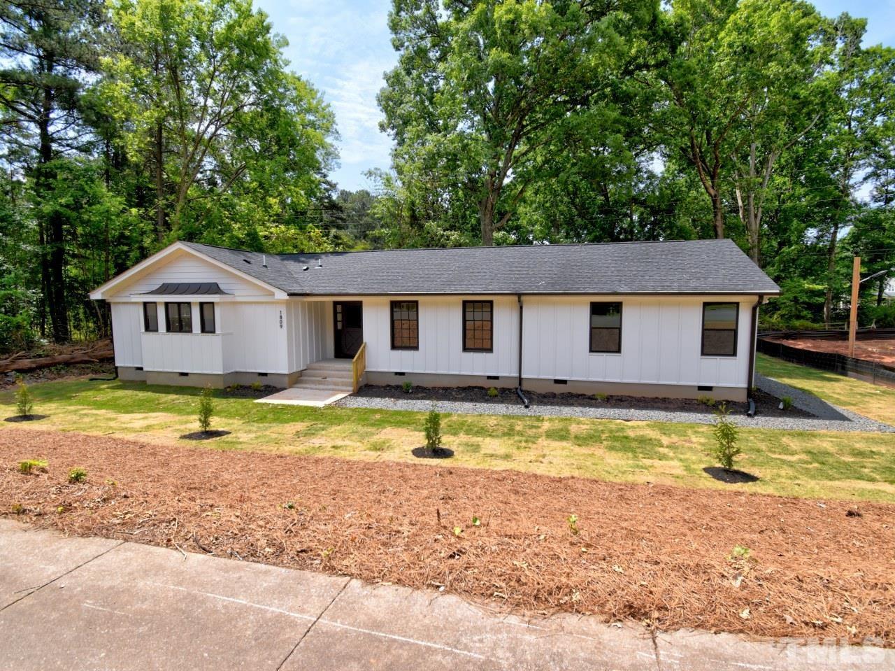 6530 Jean Drive Raleigh, NC 27612 - Photo 2 of 32 a view of a house with pool and trees in the background