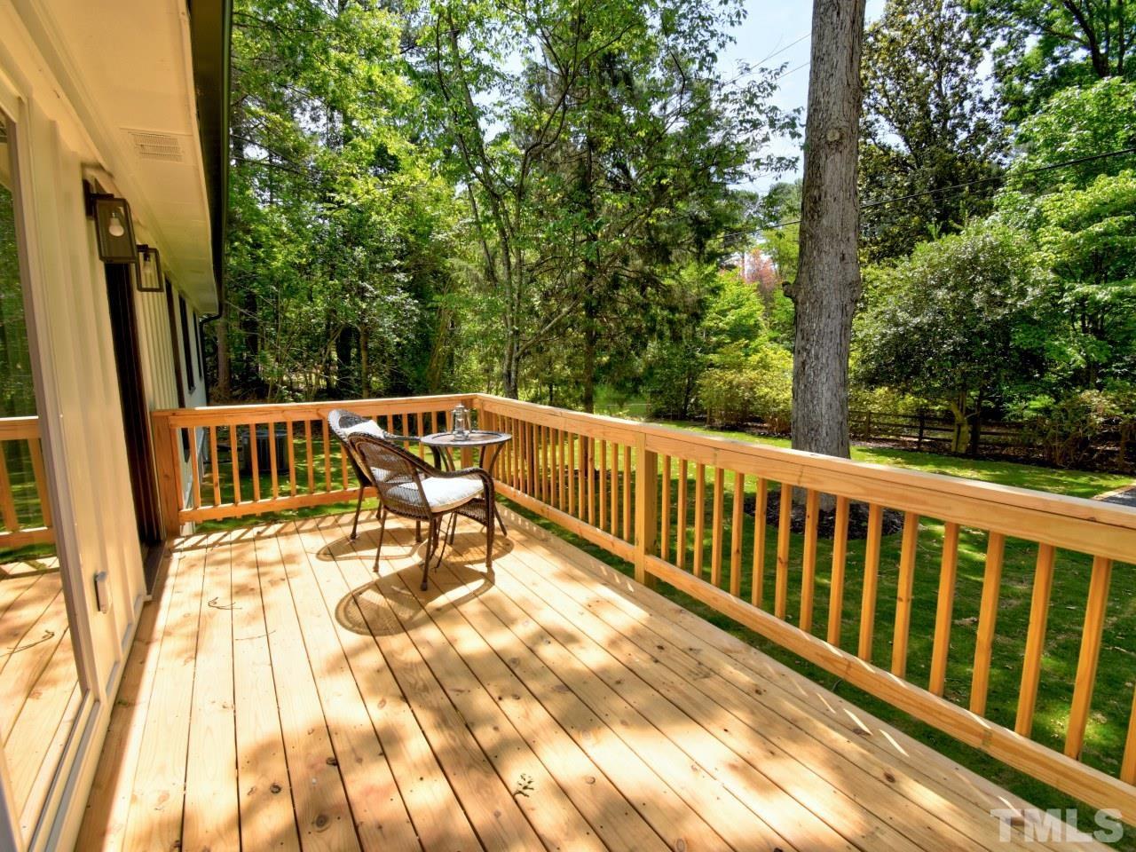 6530 Jean Drive Raleigh, NC 27612 - Photo 31 of 32 a view of balcony with wooden floor and outdoor seating