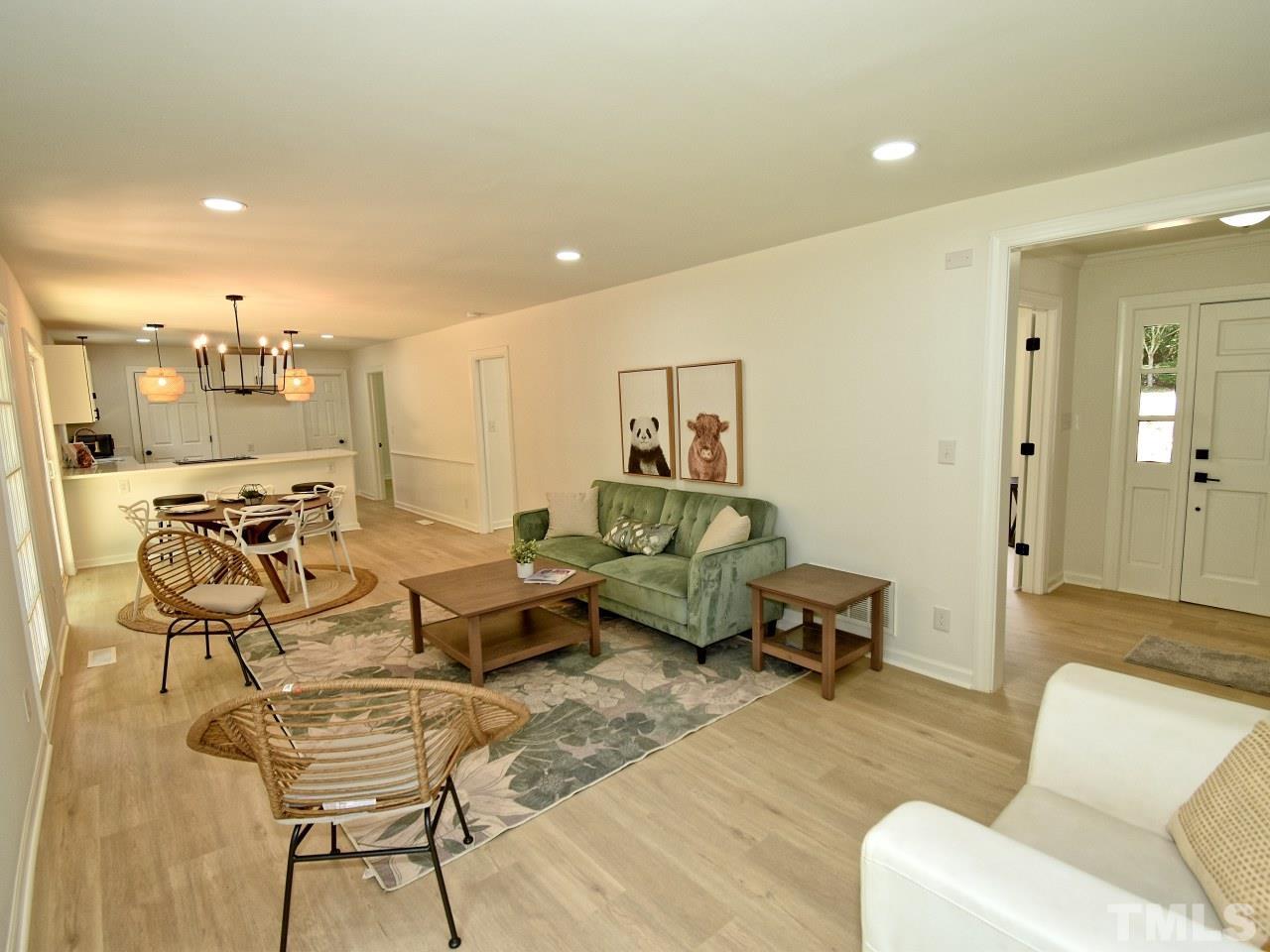 6530 Jean Drive Raleigh, NC 27612 - Photo 4 of 32 a living room with furniture and view of kitchen