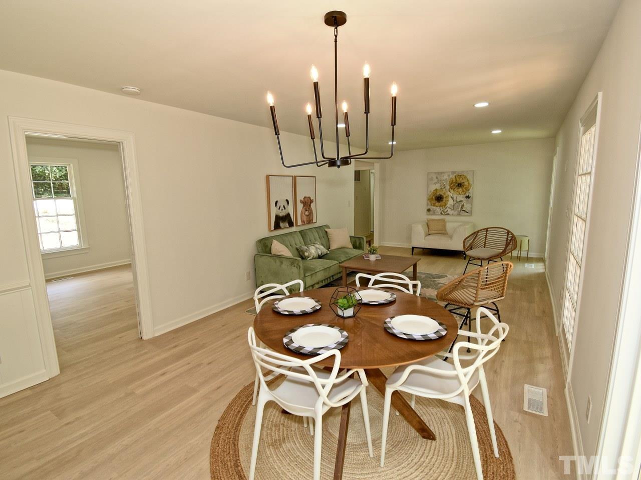 6530 Jean Drive Raleigh, NC 27612 - Photo 8 of 32 a view of a dining room with furniture and wooden floor