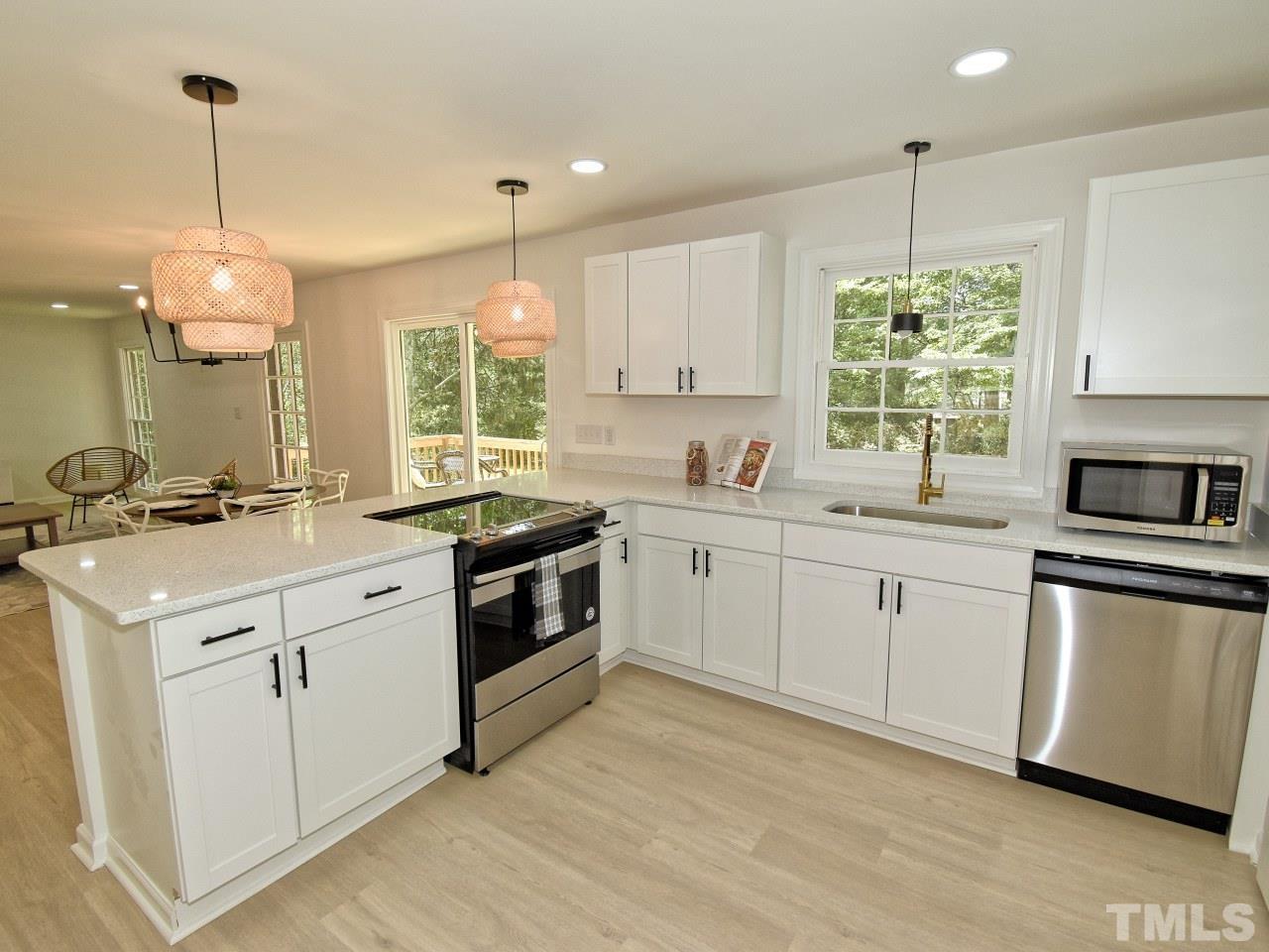 6530 Jean Drive Raleigh, NC 27612 - Photo 9 of 32 a kitchen that has a sink a window and stainless steel appliances
