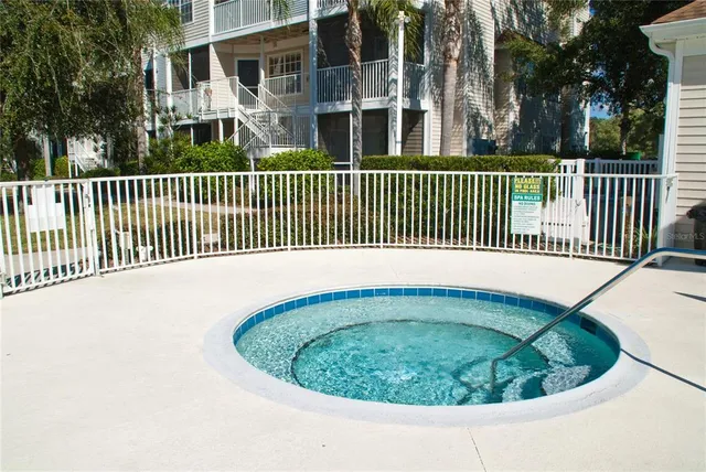 a view of a house with a wooden fence