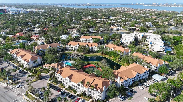 an aerial view of lake and residential houses with outdoor space