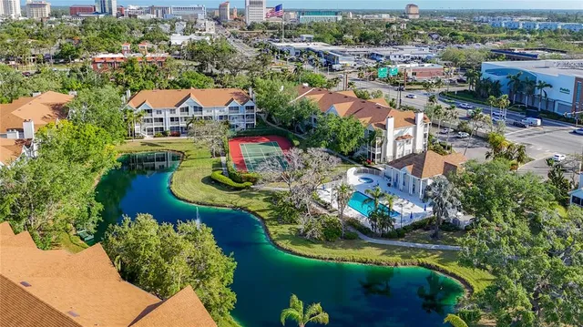 an aerial view of residential houses with outdoor space and river view