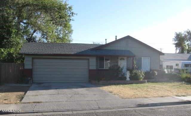1250 Castle Way Reno, NV 89512 - Photo 1 of 1 a front view of a house with a yard and garage