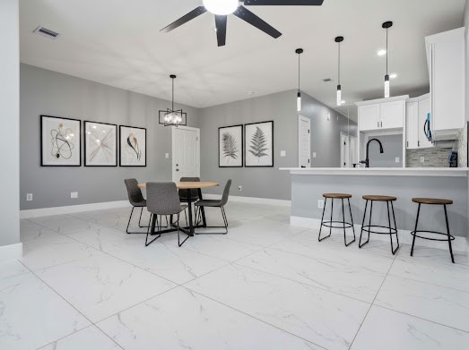 8216 Locksley Road, Unit B Houston, TX 77078 - Photo 5 of 15 a living room with furniture a dining table and a chandelier