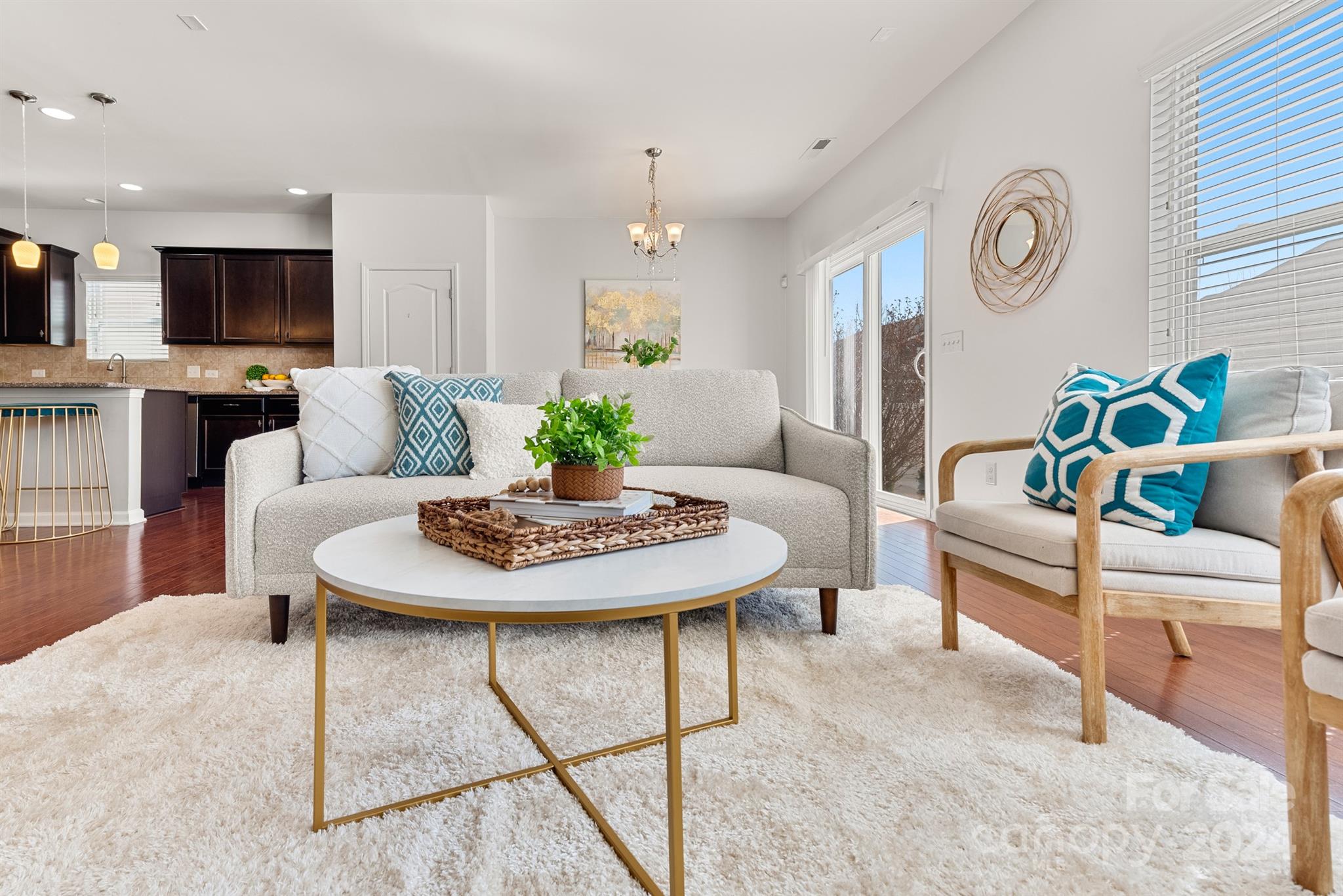 a living room with furniture and kitchen view