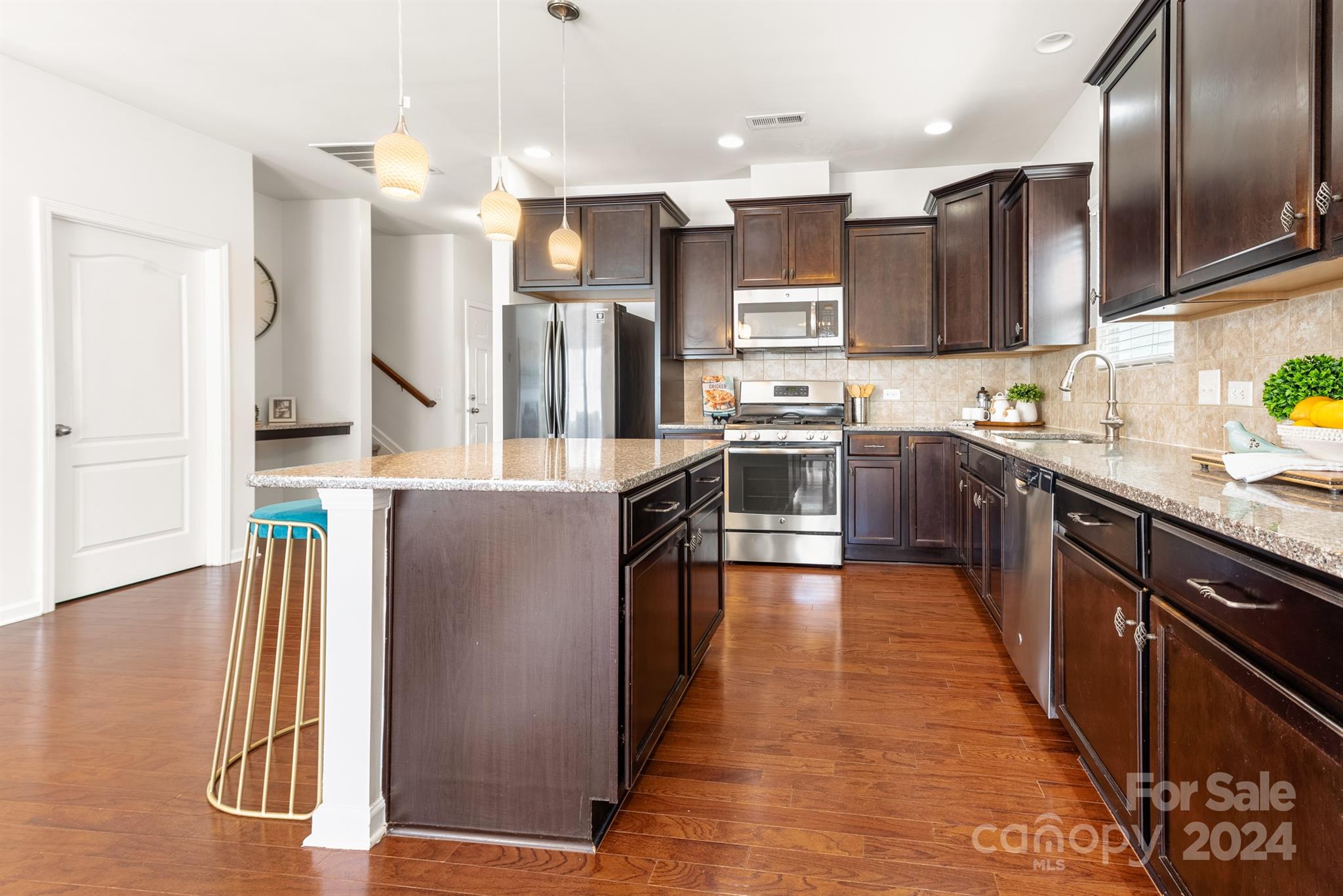 1555 Spring Blossom Trail Fort Mill, SC 29708 - Photo 11 of 47 a kitchen with stainless steel appliances granite countertop a refrigerator a sink a stove and oven
