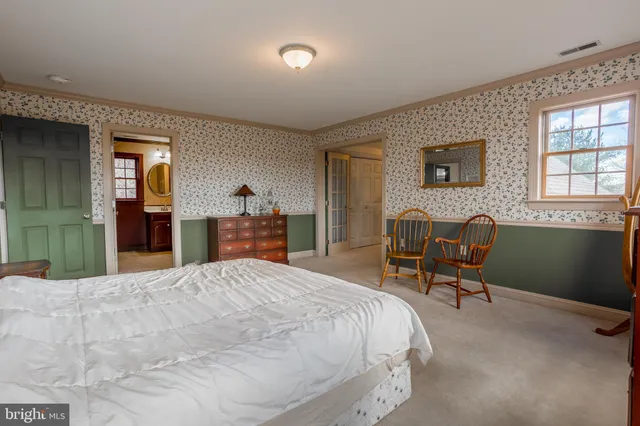 a bed room with a bed and a chair