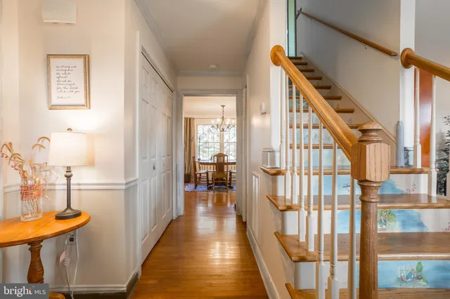 a view of entryway and hall with wooden floor