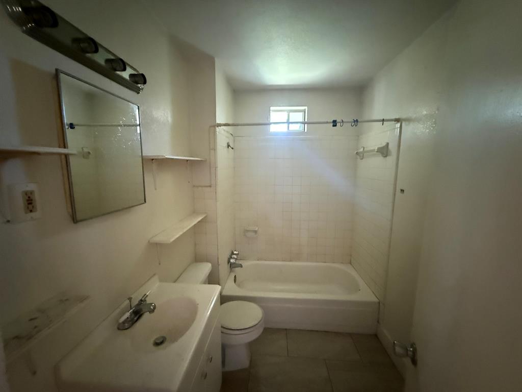 1724 McFerrin Avenue Waco, TX 76708 - Photo 6 of 11 a bathroom with a granite countertop bathtub shower sink vanity and toilet