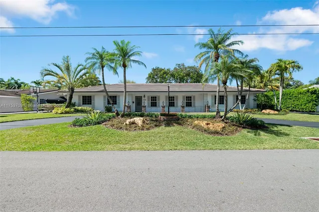 a front view of a house with a yard and porch
