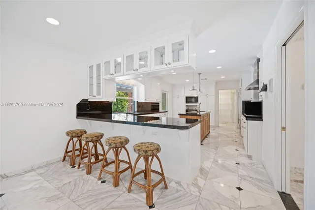 a kitchen with stainless steel appliances a refrigerator and cabinets