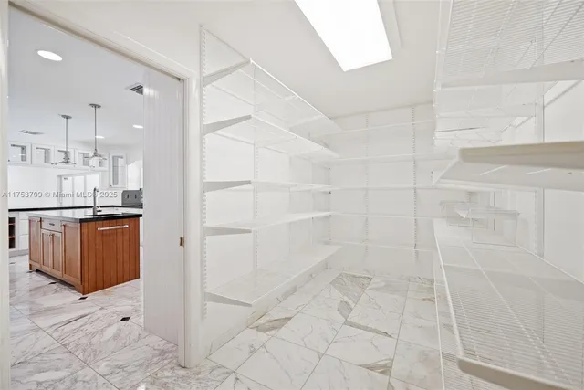 a view of a kitchen with refrigerator and cabinets