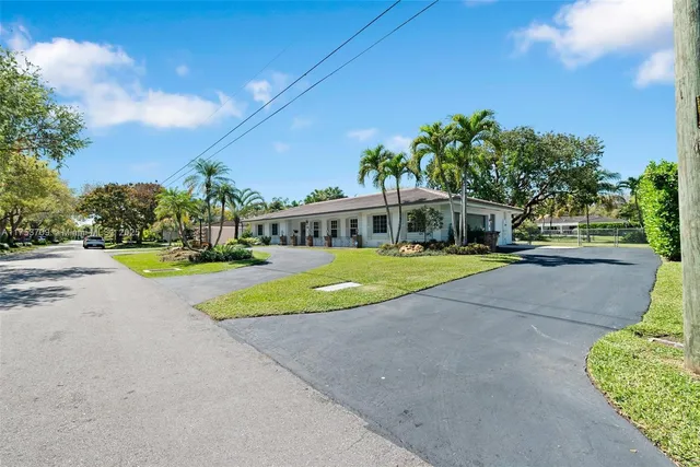 a view of green field with house in the background