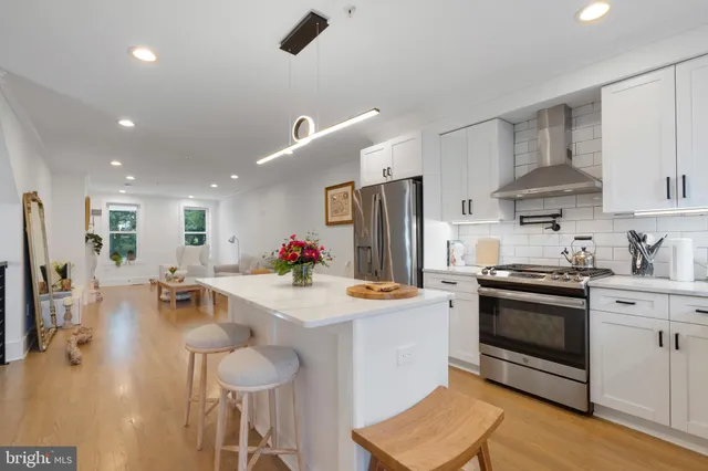 a kitchen with stainless steel appliances a stove a sink dishwasher and a refrigerator