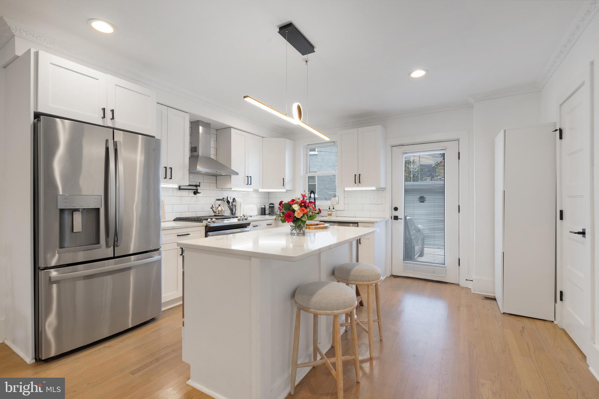 1427 West Virginia Avenue Northeast, Unit 1 Washington, DC 20002 - Photo 12 of 46 a kitchen with white cabinets and stainless steel appliances