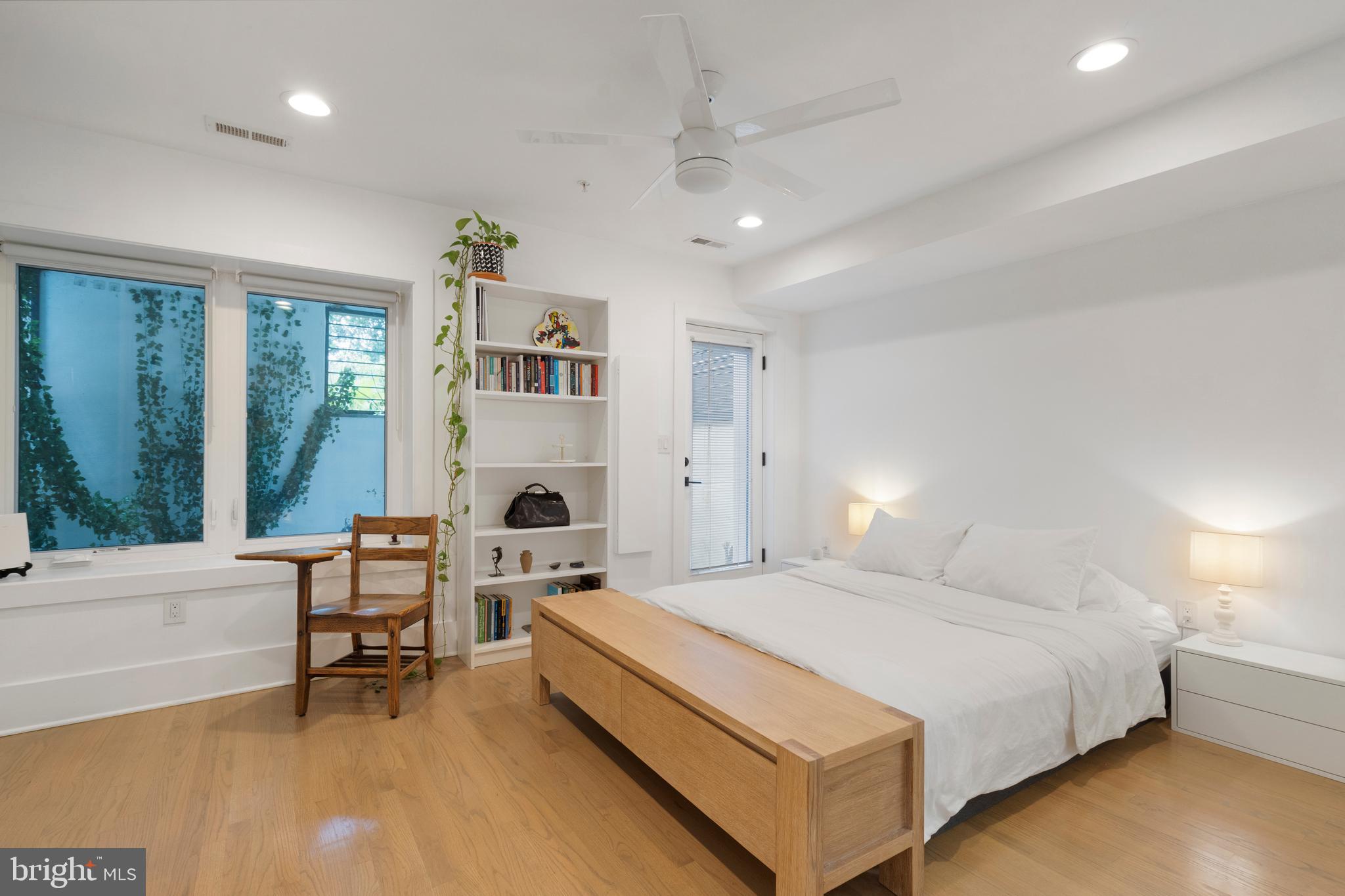 1427 West Virginia Avenue Northeast, Unit 1 Washington, DC 20002 - Photo 23 of 46 a spacious bedroom with a bed and a fireplace