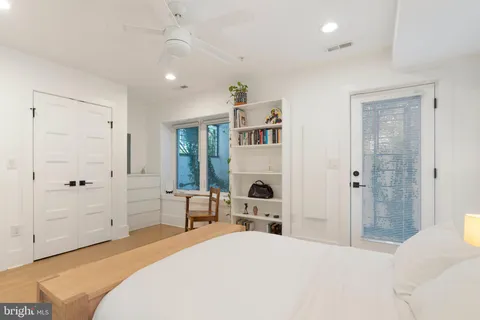 a spacious bedroom with a bed and a cabinets