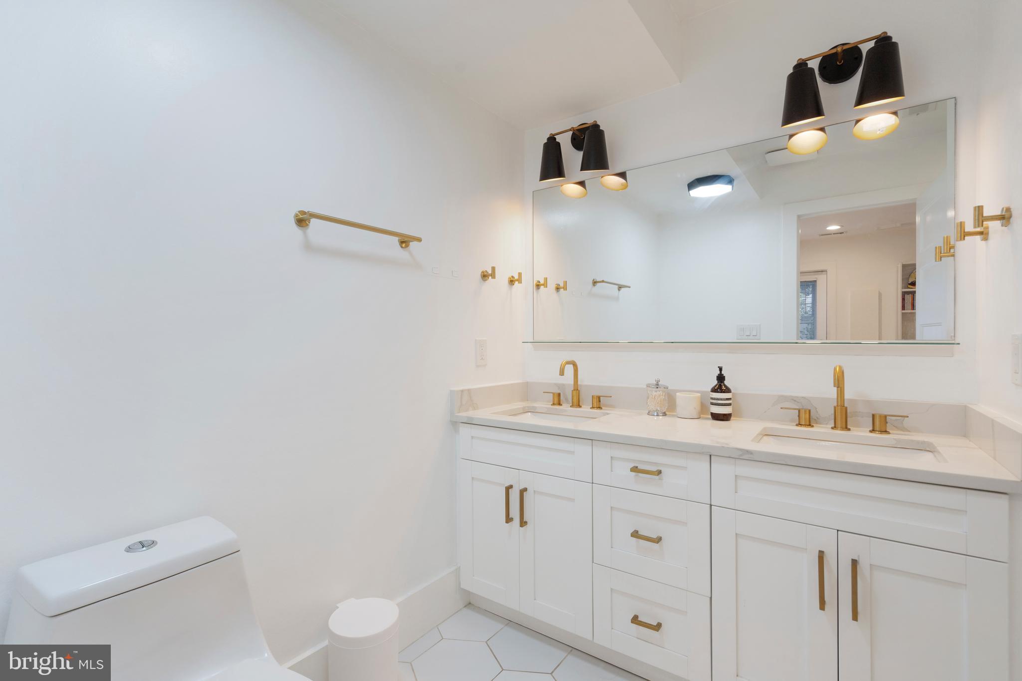 1427 West Virginia Avenue Northeast, Unit 1 Washington, DC 20002 - Photo 27 of 46 a bathroom with a toilet sink and mirror