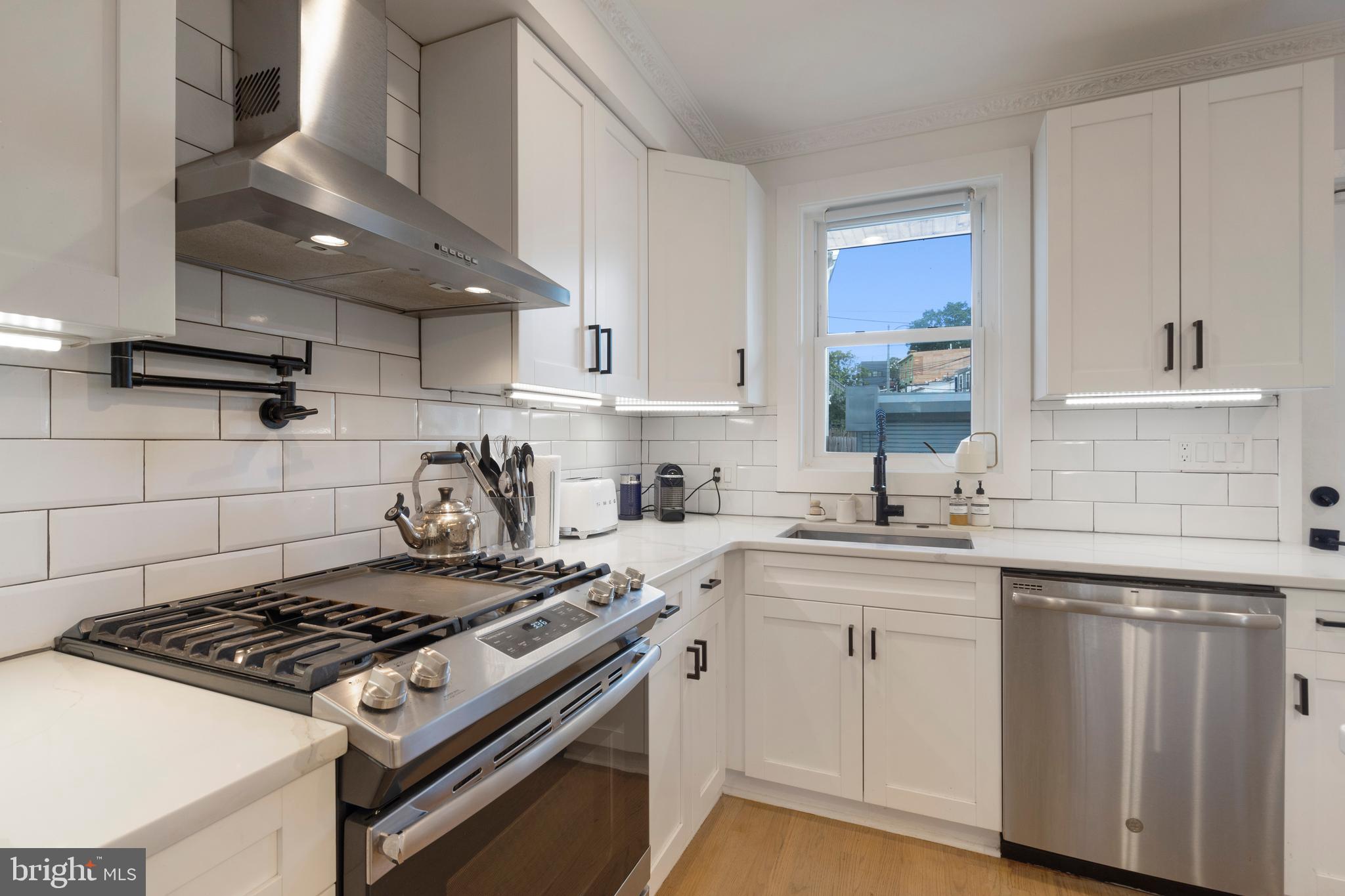 1427 West Virginia Avenue Northeast, Unit 1 Washington, DC 20002 - Photo 10 of 46 a kitchen with sink stove and cabinets