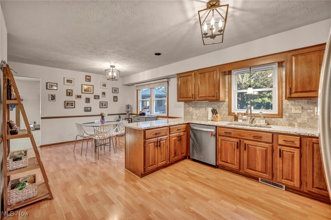 300 Decourcey Rittman, OH 44270 - Photo 20 of 48 Kitchen with a chandelier, healthy amount of natural light, and light wood finished floors