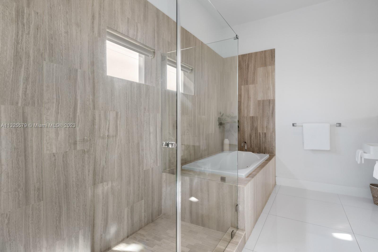 6050 La Gorce Drive Miami Beach, FL 33140 - Photo 13 of 31 a bathroom with a shower and a toilet