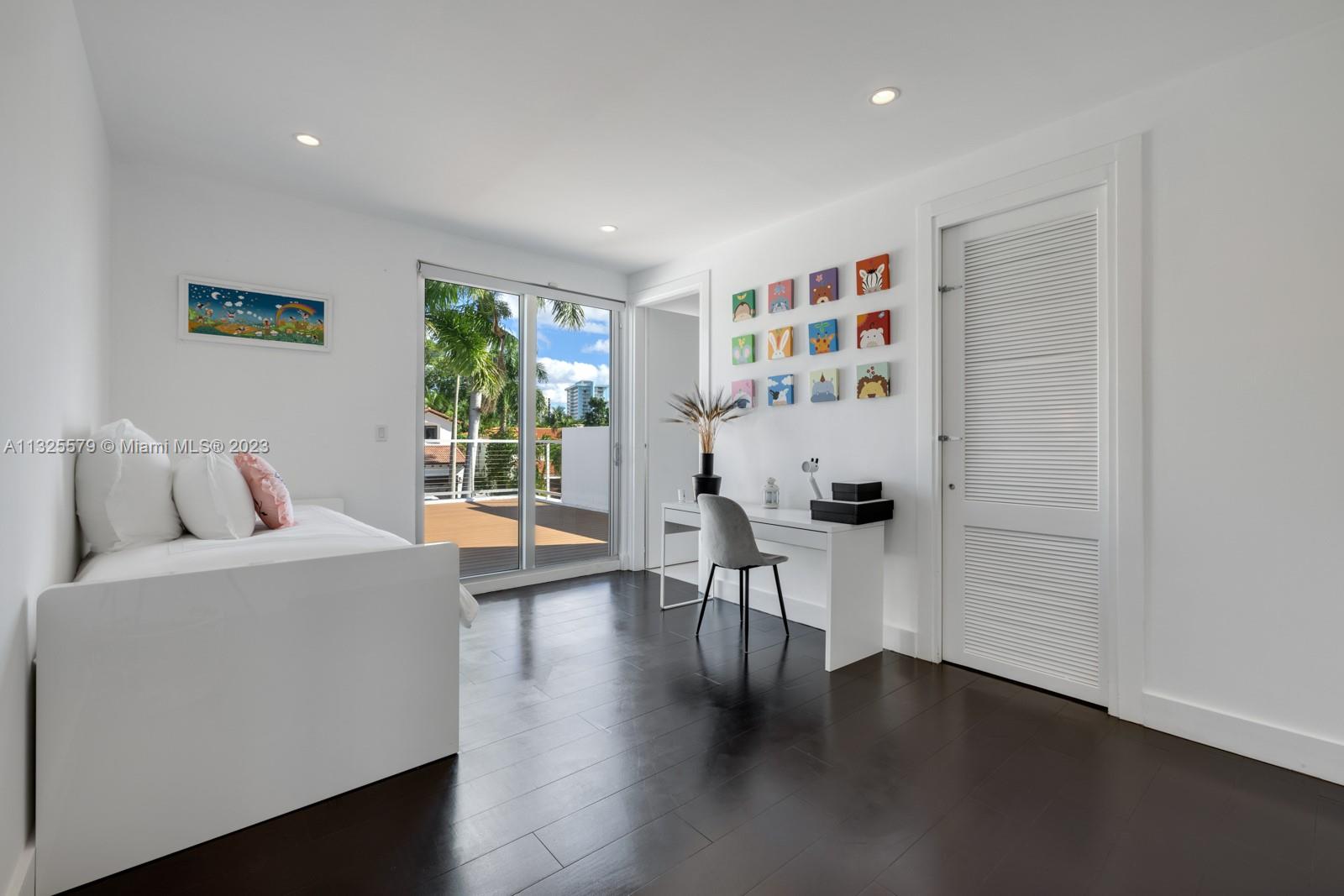 6050 La Gorce Drive Miami Beach, FL 33140 - Photo 17 of 31 a living room with furniture a window and wooden floor