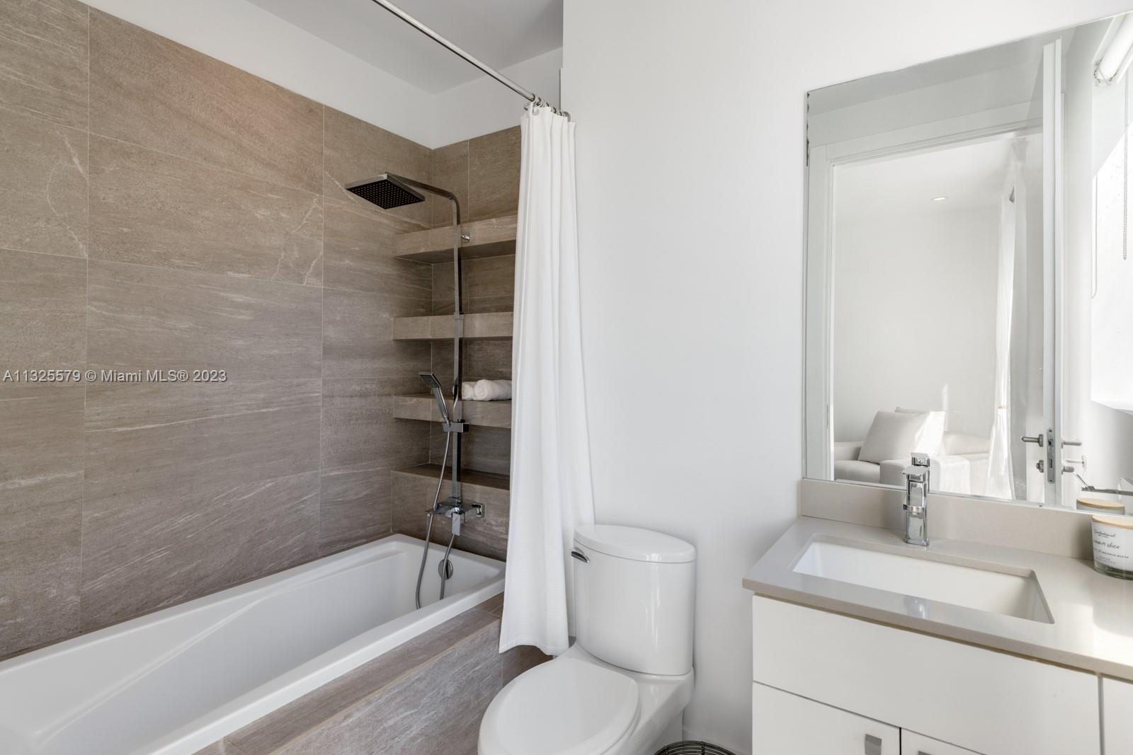 6050 La Gorce Drive Miami Beach, FL 33140 - Photo 19 of 31 a bathroom with a sink a toilet and shower