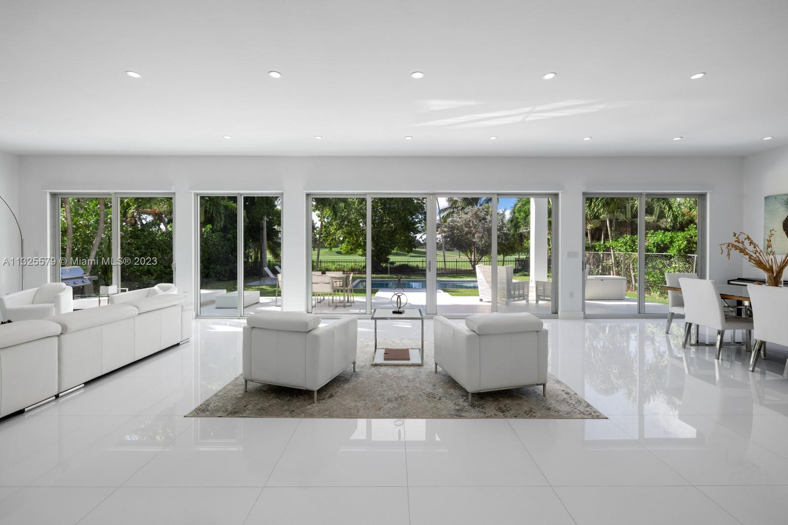 6050 La Gorce Drive Miami Beach, FL 33140 - Photo 2 of 31 a living room with furniture and large windows