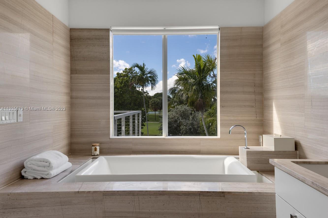 6050 La Gorce Drive Miami Beach, FL 33140 - Photo 23 of 31 a living room with furniture and a potted plant