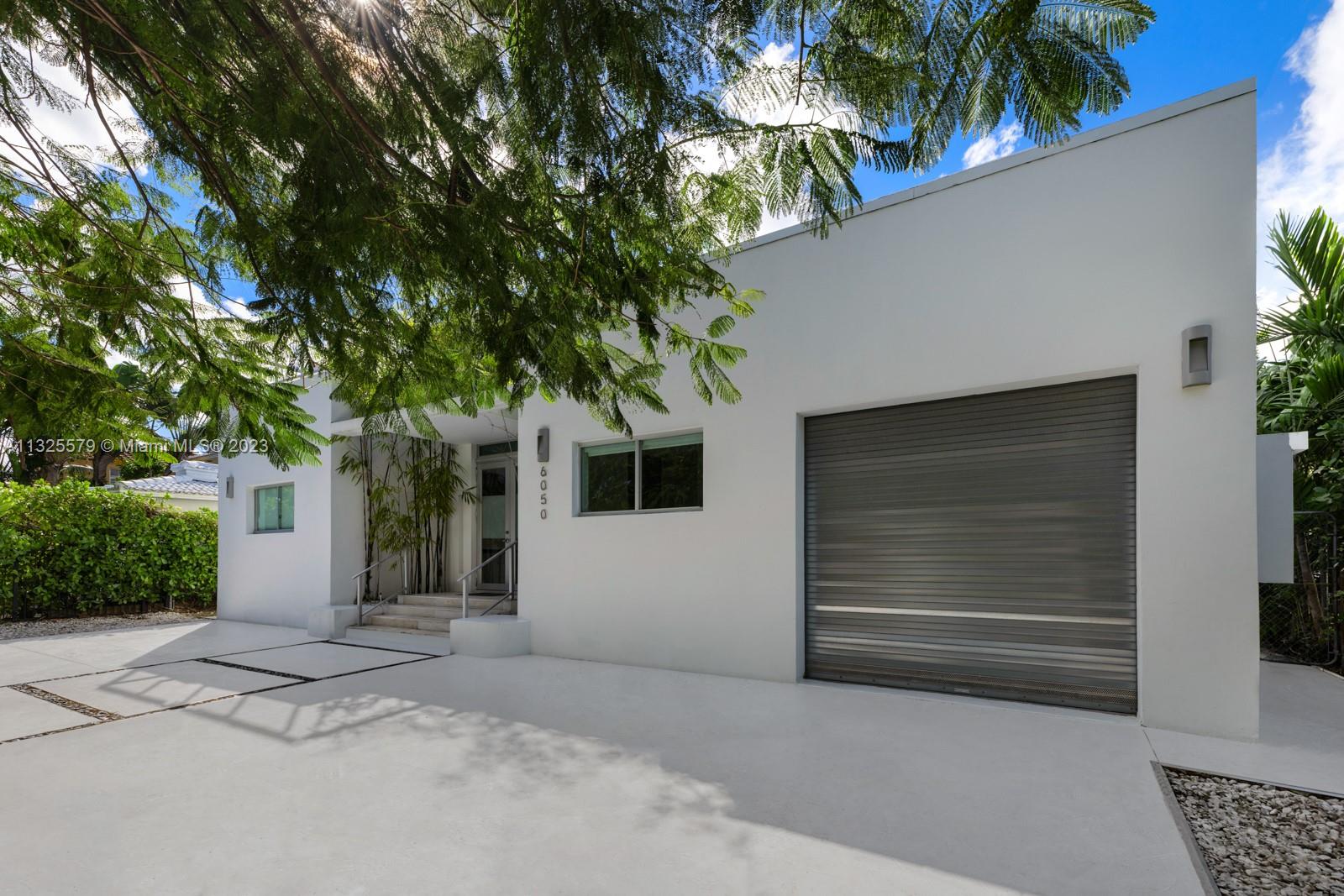 6050 La Gorce Drive Miami Beach, FL 33140 - Photo 29 of 31 a house with a tree in front of it