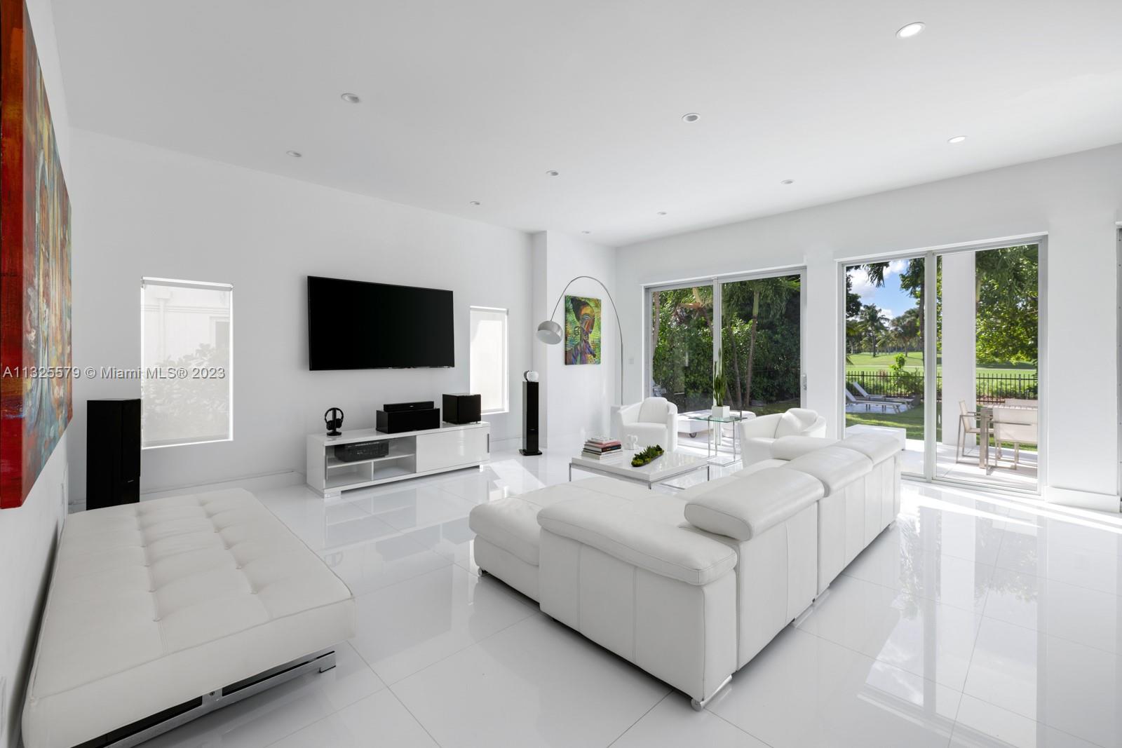 6050 La Gorce Drive Miami Beach, FL 33140 - Photo 4 of 31 a living room with furniture and a flat screen tv
