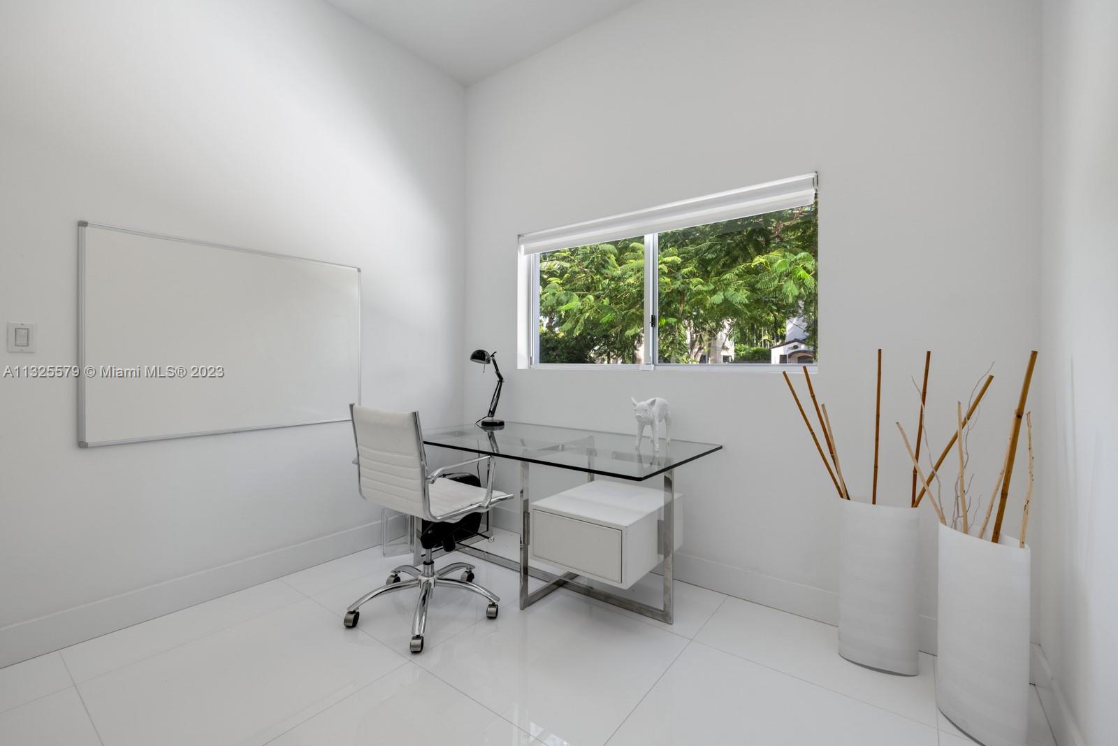 6050 La Gorce Drive Miami Beach, FL 33140 - Photo 8 of 31 a view of a workspace with furniture and a window