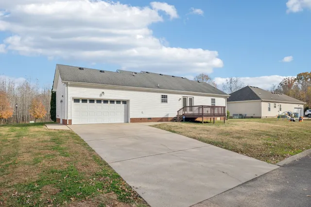 a view of a house with a yard and sitting area