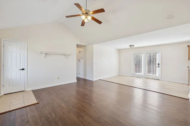 an empty room with a fireplace and window