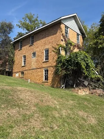 a big house with a big yard and large trees
