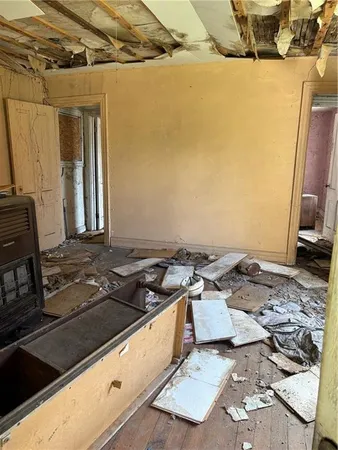 a view of an empty room with a fireplace and a window