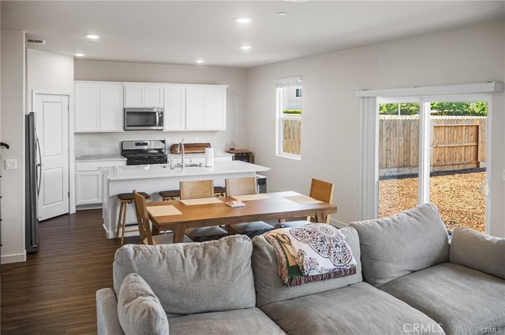 4119 Anise Court Merced, CA 95348 - Photo 4 of 17 a living room with stainless steel appliances granite countertop furniture and a wooden floor