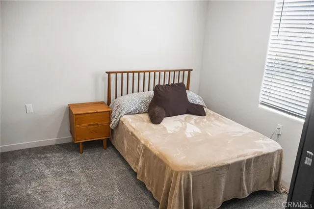 a bed sitting in a bedroom next to a window