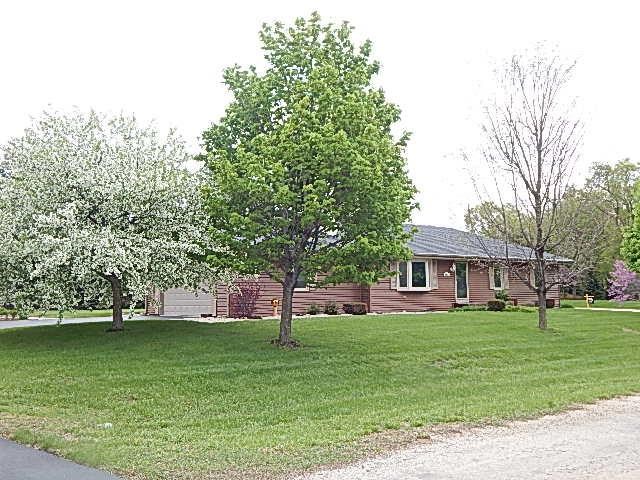 9925 Bitterroot Road Roscoe, IL 61073 - Photo 1 of 25 a view of a house with a yard