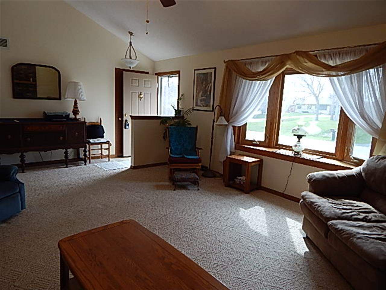 9925 Bitterroot Road Roscoe, IL 61073 - Photo 11 of 25 a living room with furniture and a flat screen tv