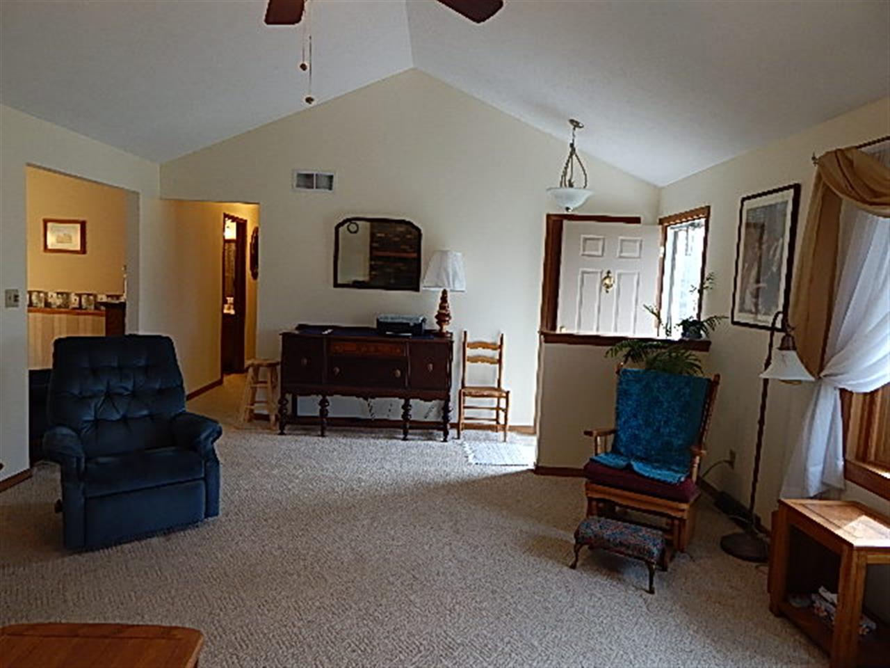 9925 Bitterroot Road Roscoe, IL 61073 - Photo 12 of 25 a living room with furniture and a flat screen tv