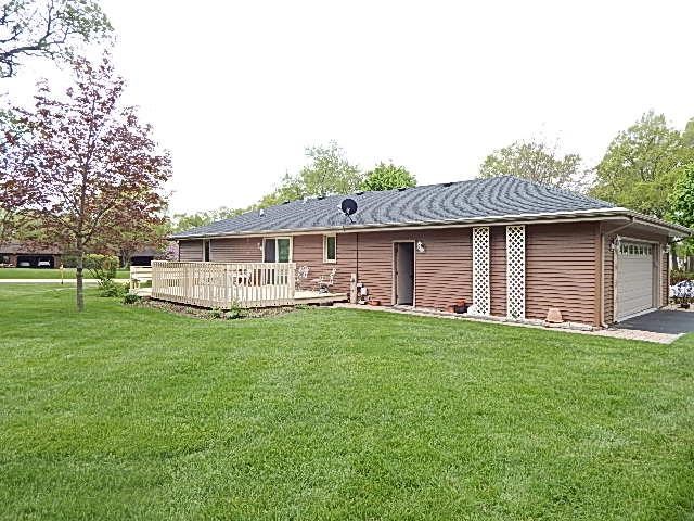 9925 Bitterroot Road Roscoe, IL 61073 - Photo 3 of 25 a front view of a house with a garden