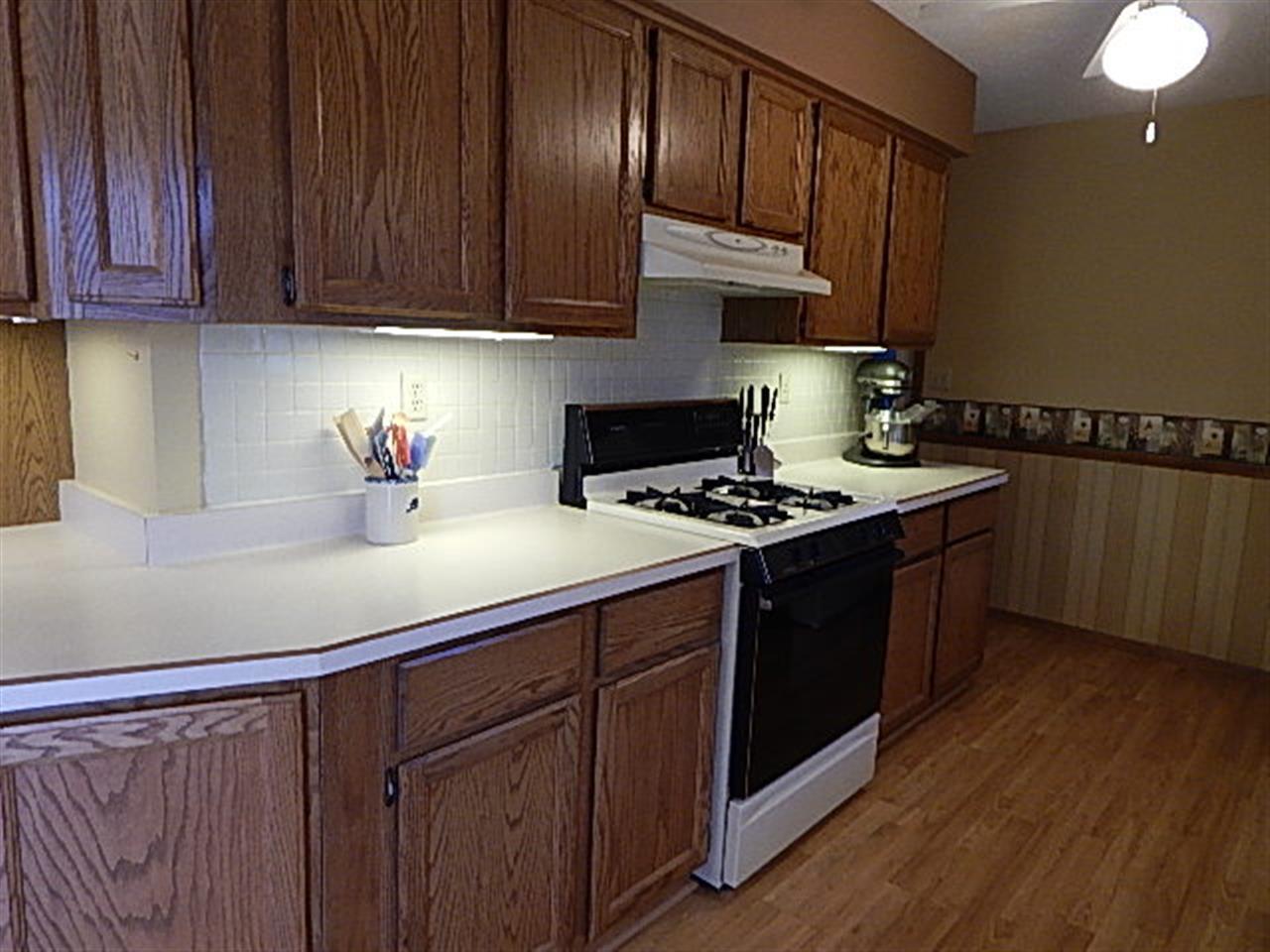 9925 Bitterroot Road Roscoe, IL 61073 - Photo 6 of 25 a kitchen with stainless steel appliances wooden cabinets and a sink