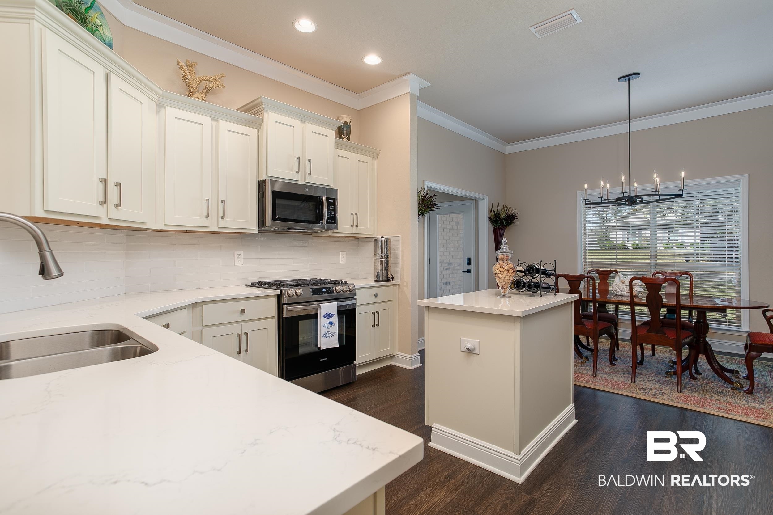 13154 Vincent Court Foley, AL 36535 - Photo 2 of 41 Kitchen featuring a sink, dark wood finished floors, stainless steel appliances, visible vents, and an inviting chandelier