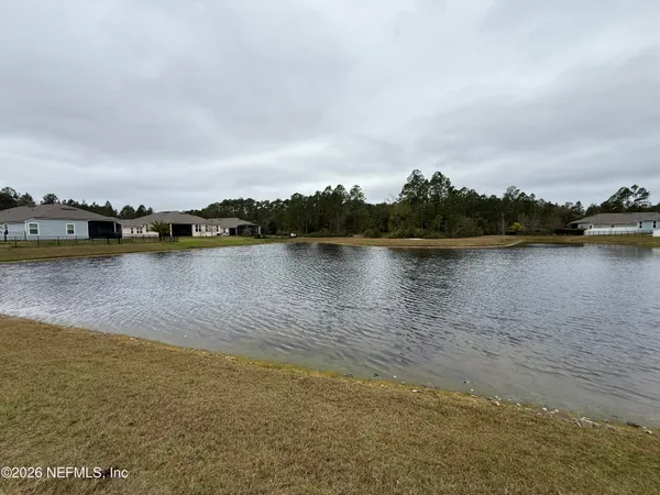 a view of a lake with houses in the back