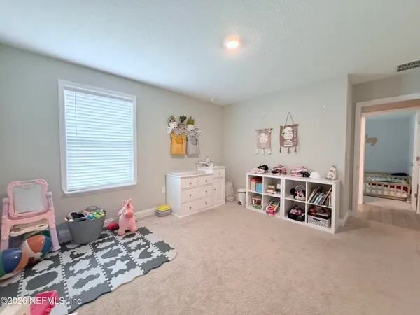 a bedroom with furniture and a window