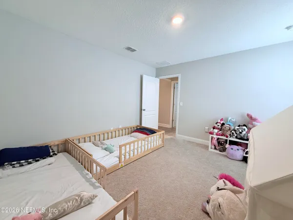 a bedroom with a bed and cabinets